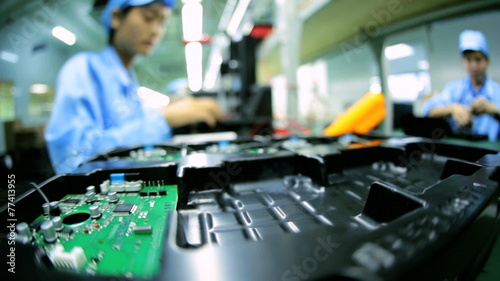 Technology female Chinese worker producing PCBs, China