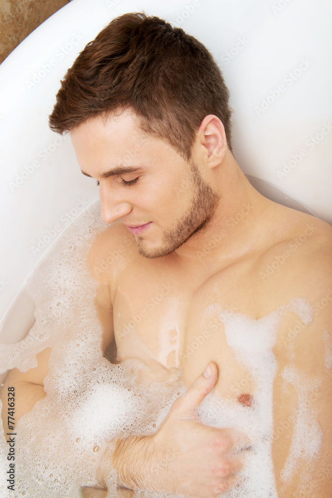 Handsome man taking a bath. Handsome man taking a bath.
