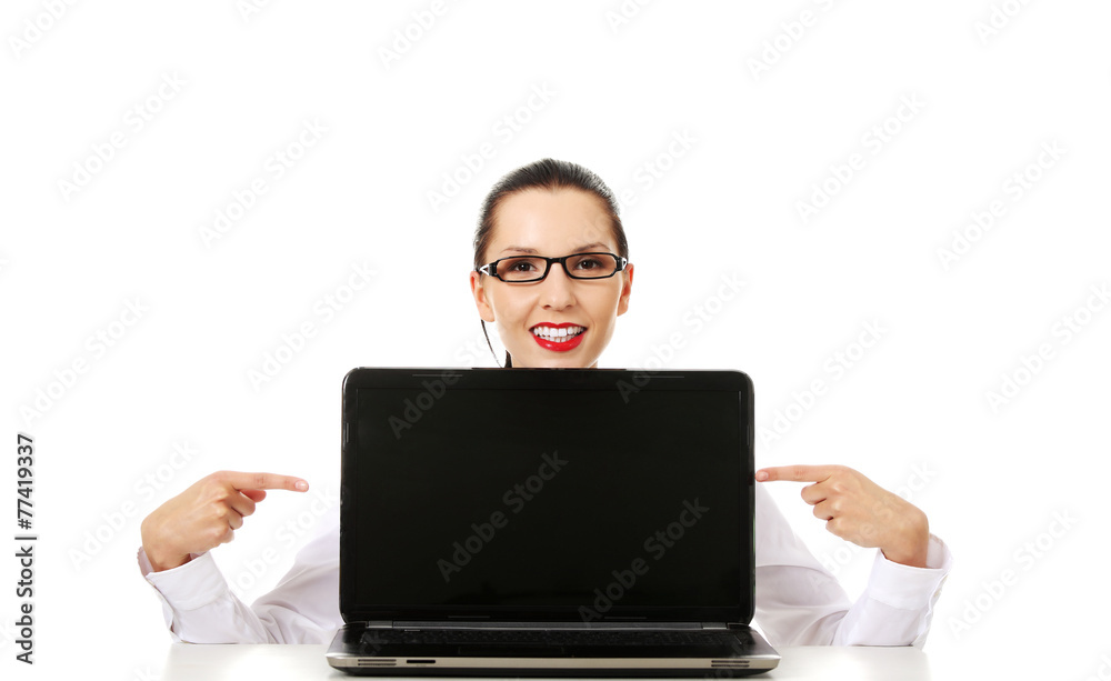 Woman with laptop points to the screen. Woman with laptop points to the screen.