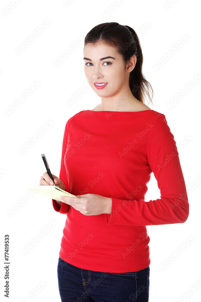 Woman writing notes and planning her schedule Woman writing notes and planning her schedule
