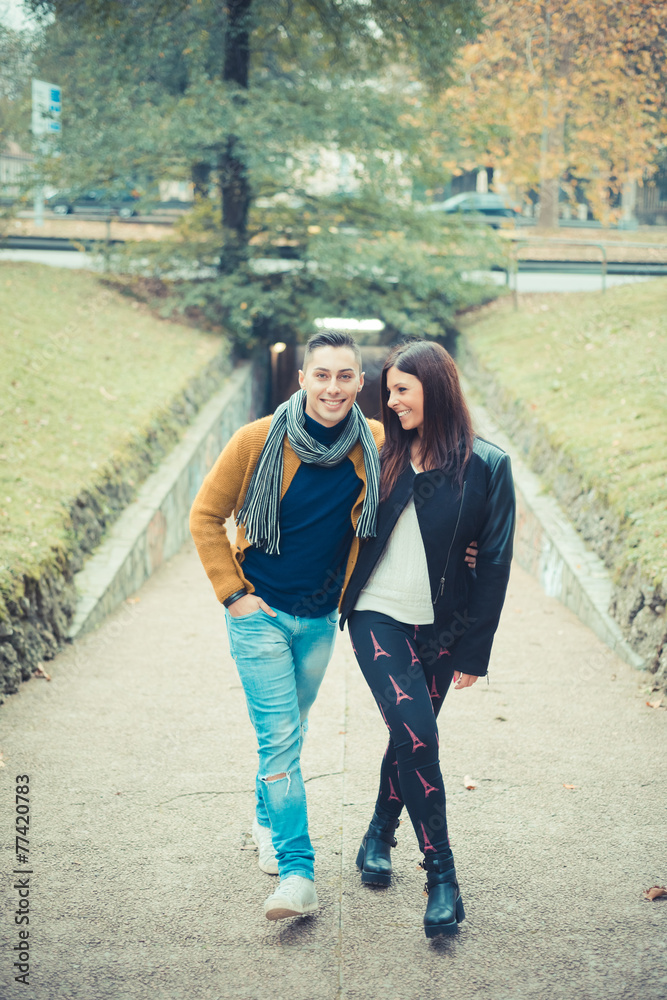 young couple in the park during autumn season outdoor young couple in the park during autumn season outdoor