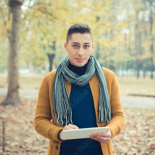 young handsome caucasian man in autumn park photo