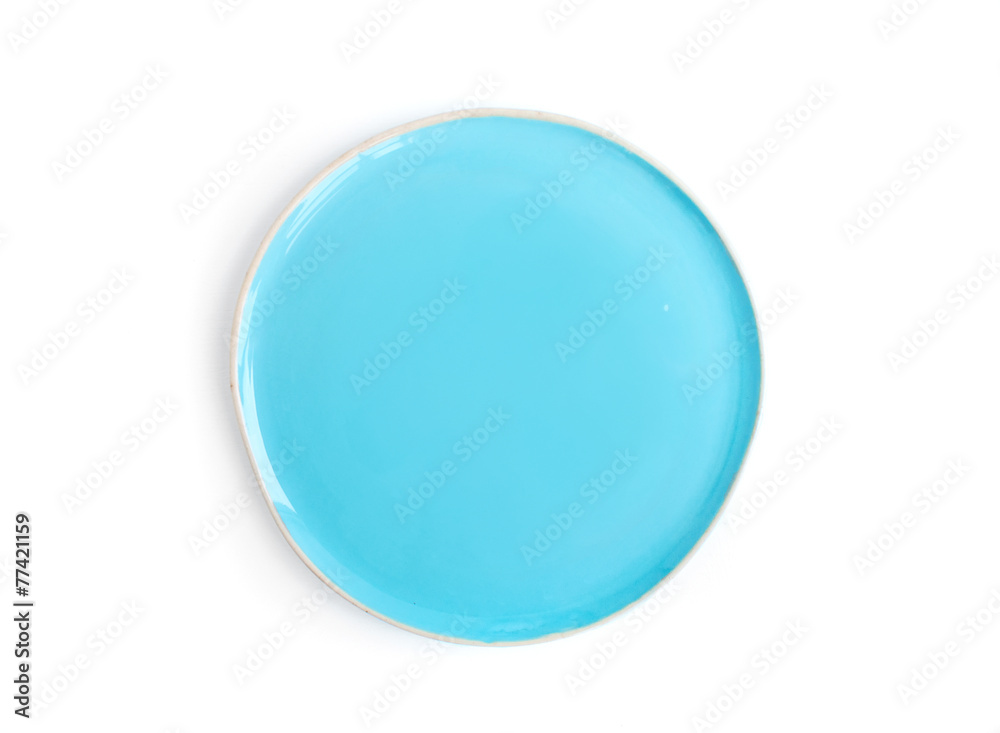 A round light blue glazed ceramic plate (dish) on a white backgr A round light blue glazed ceramic plate (dish) on a white backgr