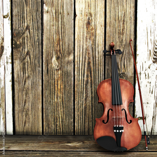 Violin leaning on a wooden fence. Room for text or copy space. © Digital Storm