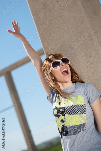 Happy casual young girl posing with sunglasses
