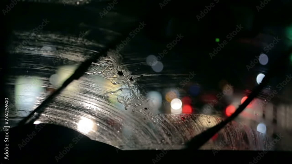 Car windscreen wipers are removing the moistere from the windshield
