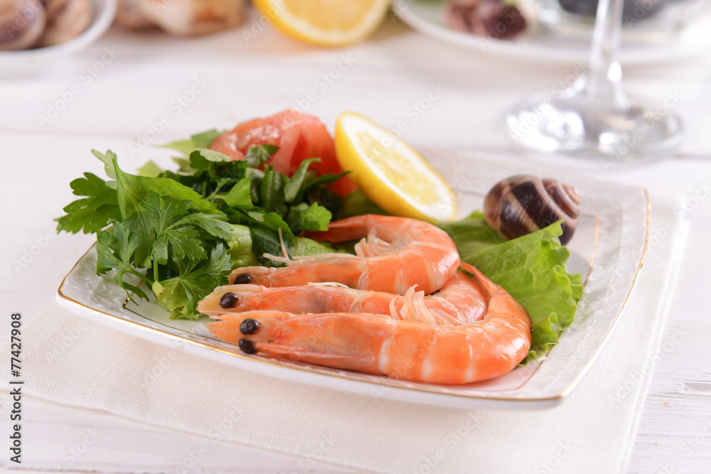 Tasty seafood on plate on table close-up Tasty seafood on plate on table close-up
