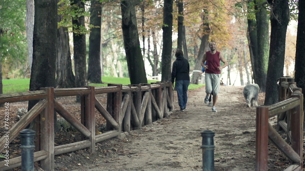 Young couple jogging in park during autumn Young couple jogging in park during autumn
