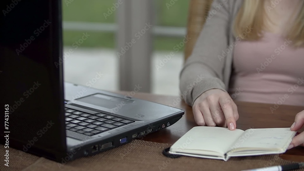 Daughter looks at the data in her notes and tries to figure something out Daughter looks at the data in her notes and tries to figure something out