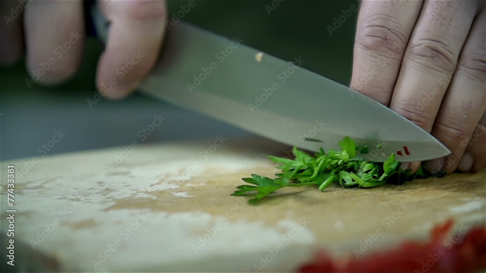 Close up slicing of parsley on a wooden desk Close up slicing of parsley on a wooden desk