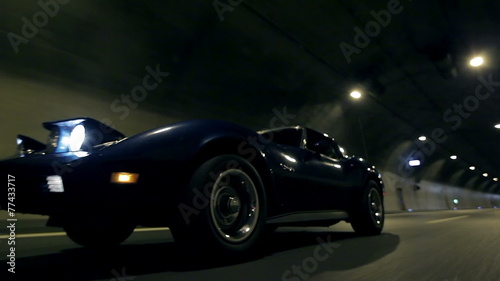 Beautiful low angle shot of car driving through tunnel at night