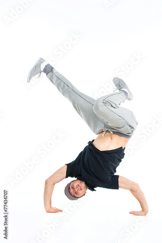 young break dancer showing his skills on white background.