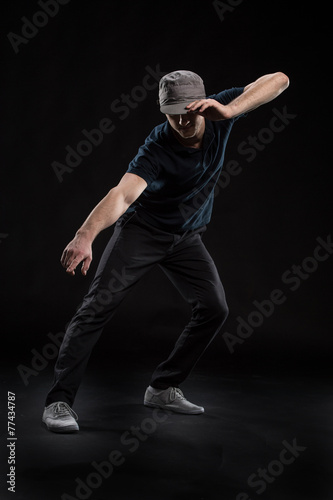 young dancer isolated on black background in studio.