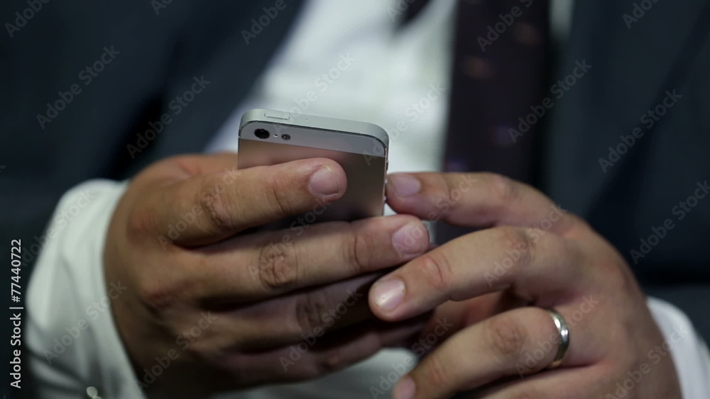 Detail of some hands typing into the mobile phone Detail of some hands typing into the mobile phone