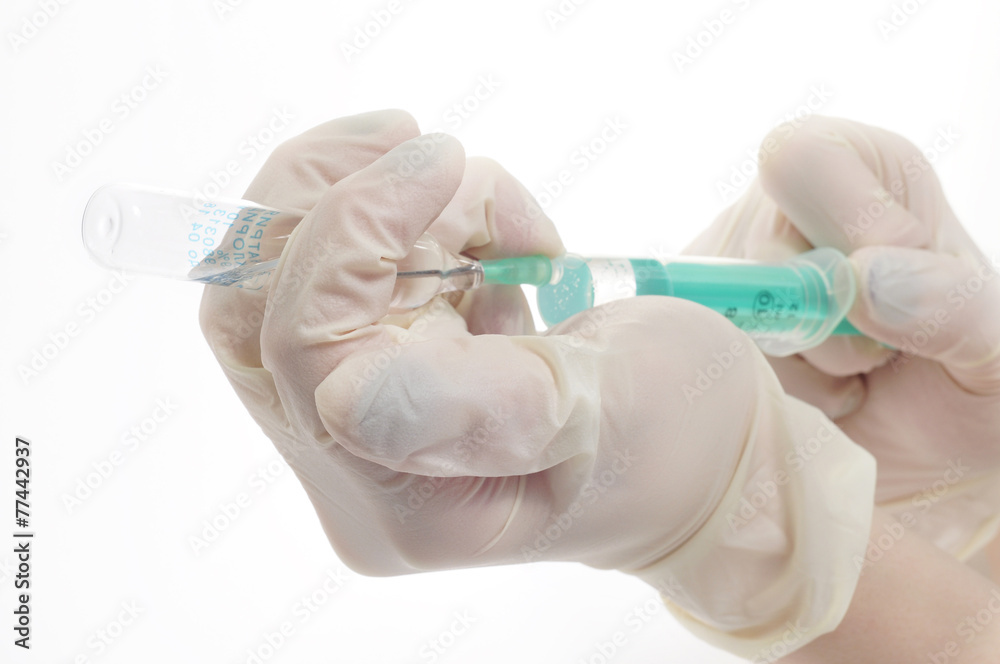 Nurse gaining medicine into the syringe Nurse gaining medicine into the syringe