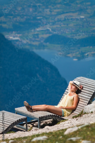 Girl relaxing on a chaise longue in Alps mountains,Austria