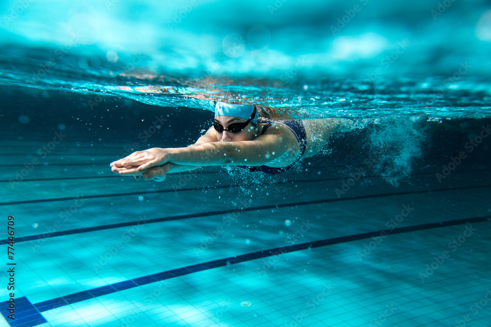 Fotografie, Obraz Female swimmer at the swimming pool.Underwater photo. |  Posters.cz
