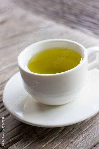Hot green tea on wood table.
