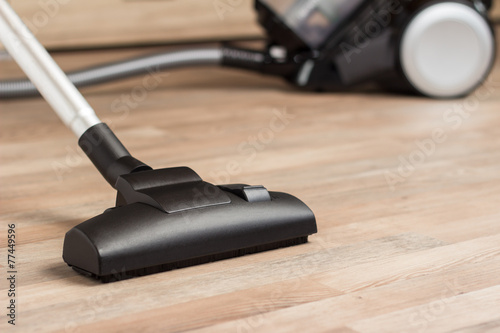 Vacuuming a thick pile white carpet