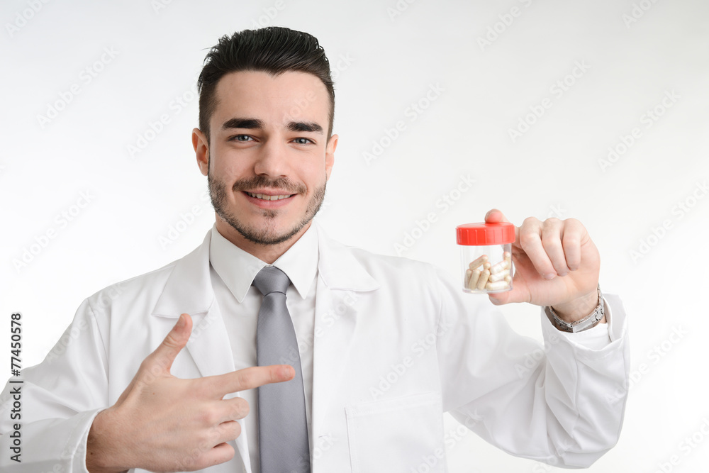 young man chemist on white coat showing bottle of pills young man chemist on white coat showing bottle of pills