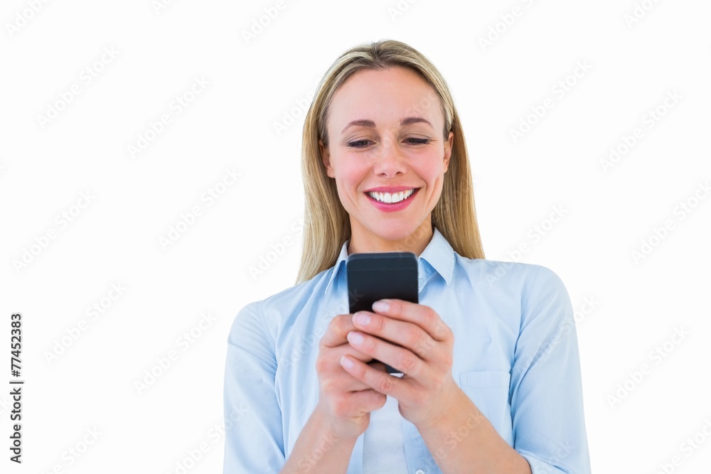 Smiling blonde sending a text message Smiling blonde sending a text message