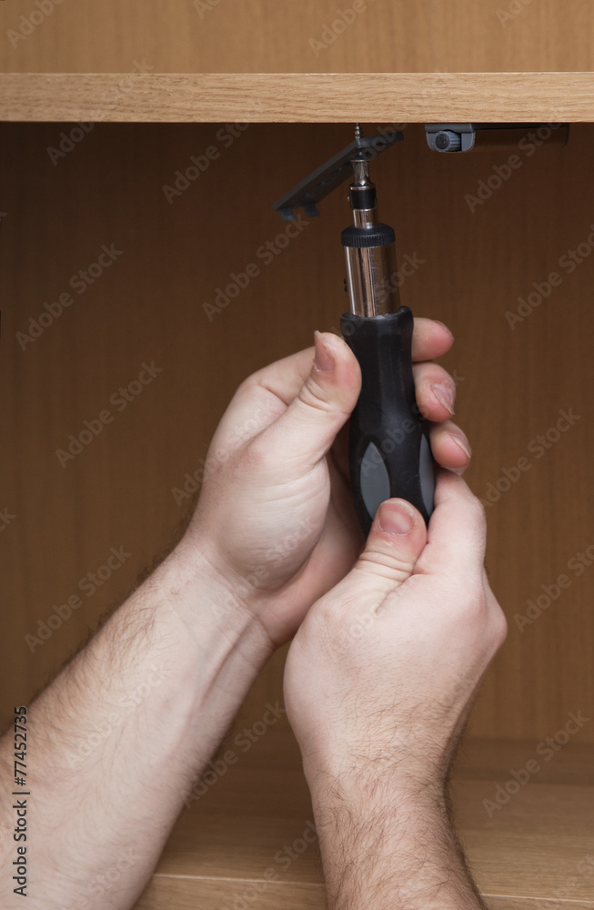 Hands with a screwdriver Hands with a screwdriver