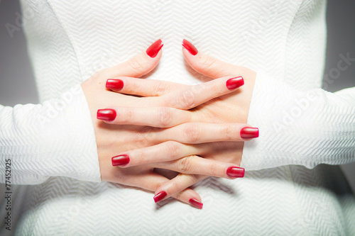 Woman showing her red nails  manicure