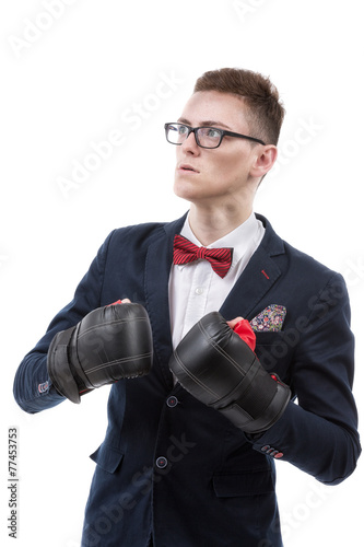 Attractive young caucasian businessman wearing boxing gloves.