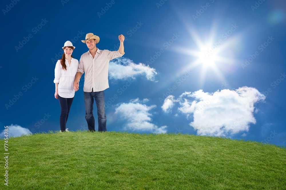 Composite image of smiling couple both wearing hats Composite image of smiling couple both wearing hats