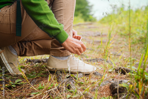 Hiker woman tying a shoelaces