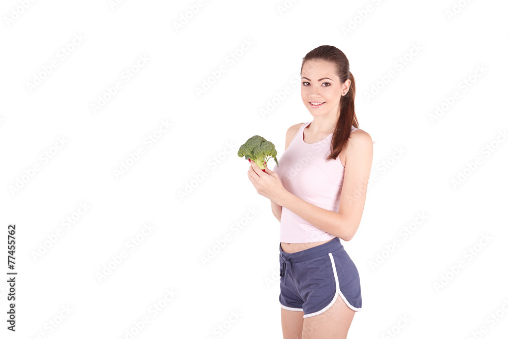 Pretty young woman smiling while holding some broccoli! Pretty young woman smiling while holding some broccoli!