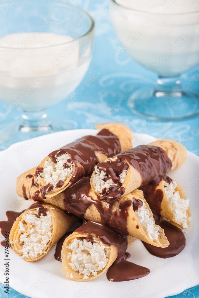 Rolled pancakes with chocolate and milk Rolled pancakes with chocolate and milk