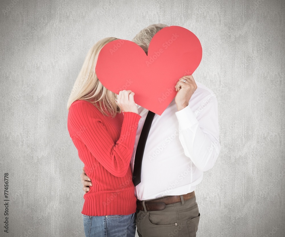 Composite image of handsome man getting a heart card form wife Composite image of handsome man getting a heart card form wife