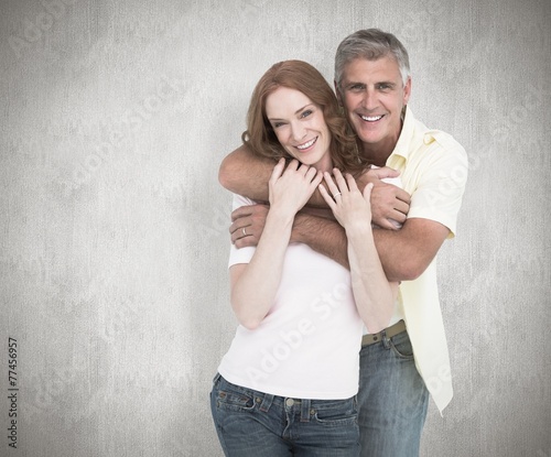 Composite image of casual couple smiling and hugging