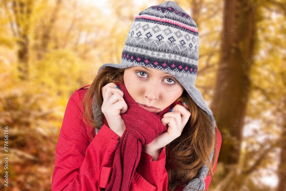 Composite image of cold redhead wearing coat and hat Composite image of cold redhead wearing coat and hat