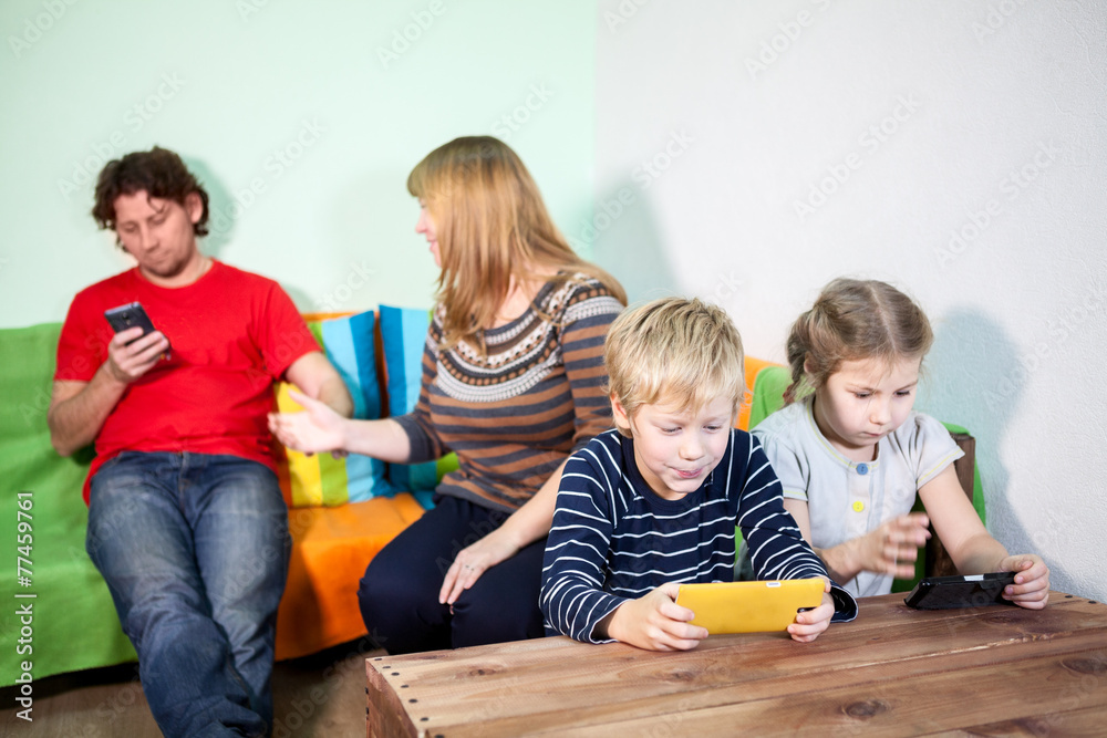 Husband playing on cellphone, wife trying to take away gadget Husband playing on cellphone, wife trying to take away gadget