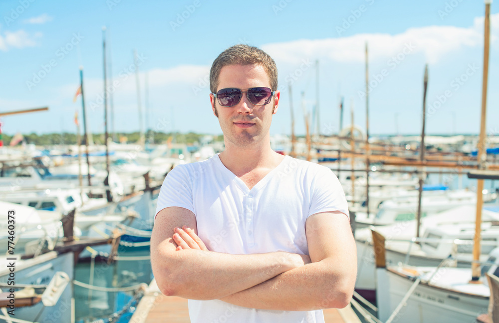Man portrait against of the pier with yachts.