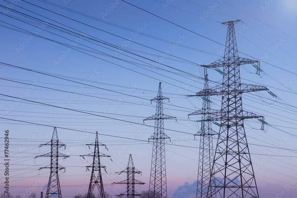 Electrical tower on a background of sunset and pipe Electrical tower on a background of sunset and pipe