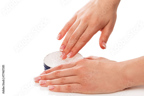 Woman applying moisturizer cream on hands