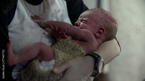 Mother holds her playful baby in her arms  photo