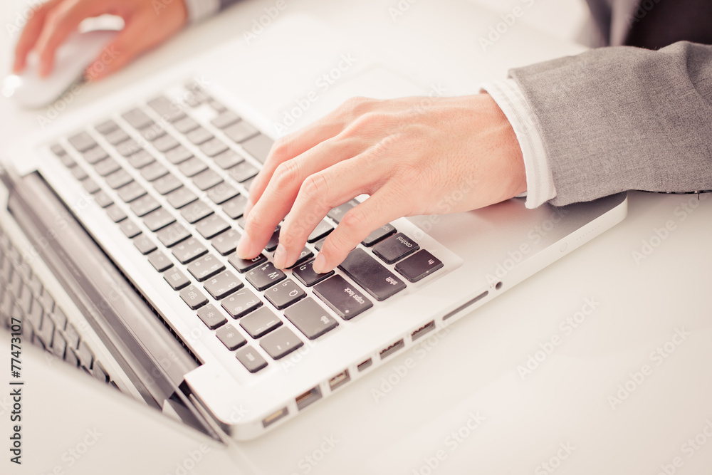 Closeup of businessman hands typing on laptop computer Closeup of businessman hands typing on laptop computer