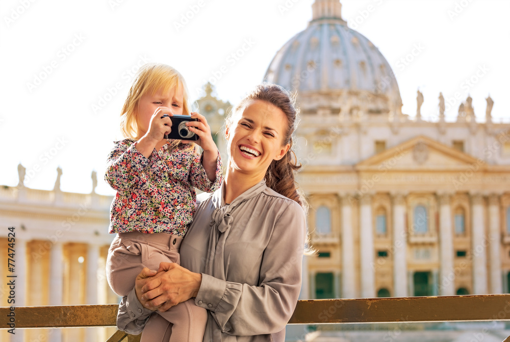Mother and baby girl with photo camera in Vatican