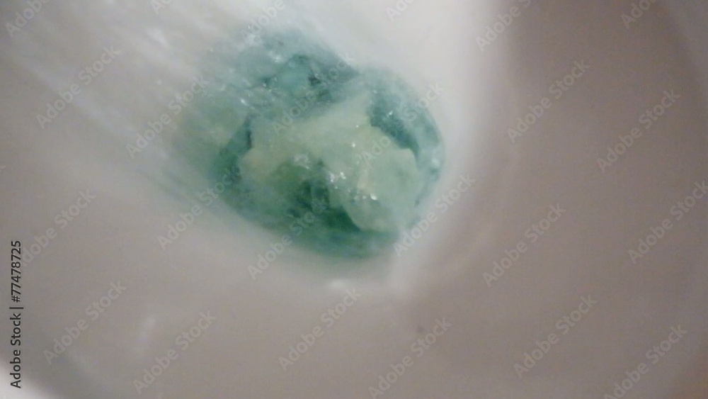 Toilet bowl with paper and blue water working hd footage Toilet bowl with paper and blue water working hd footage