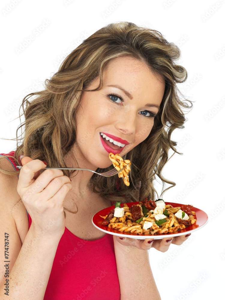 Young Woman Eating a Feta Cheese and Tommato Pasta Salad Young Woman Eating a Feta Cheese and Tommato Pasta Salad