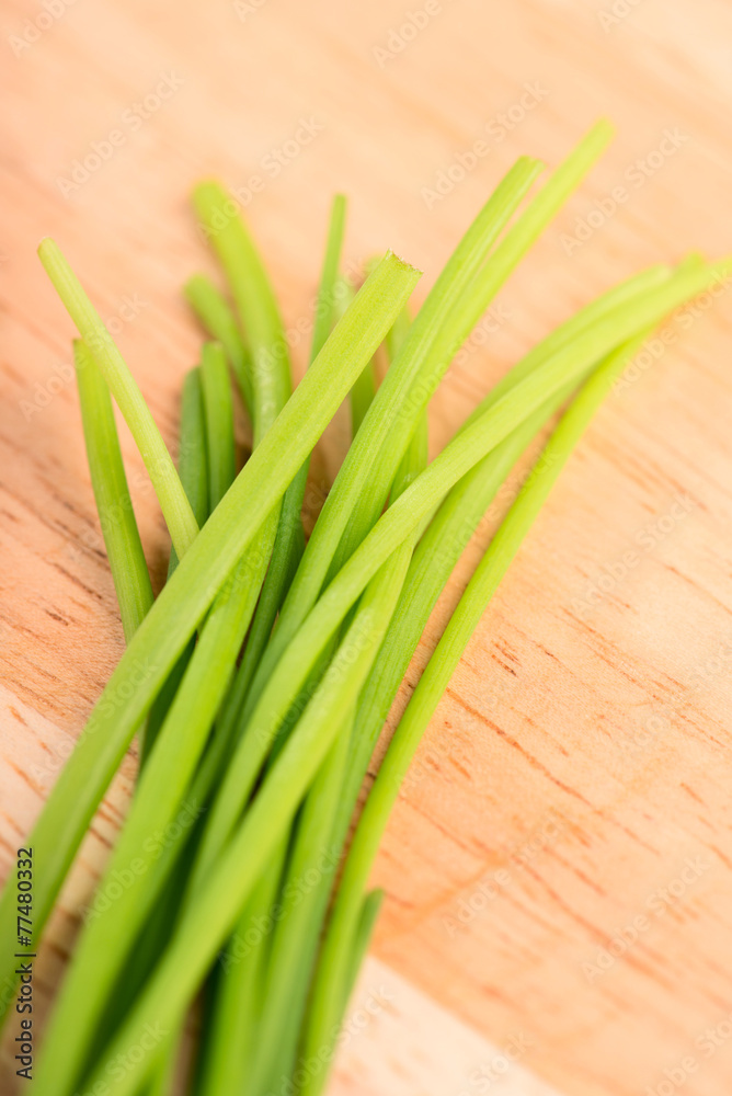 chives close up on a wooden table - selective focus chives close up on a wooden table - selective focus