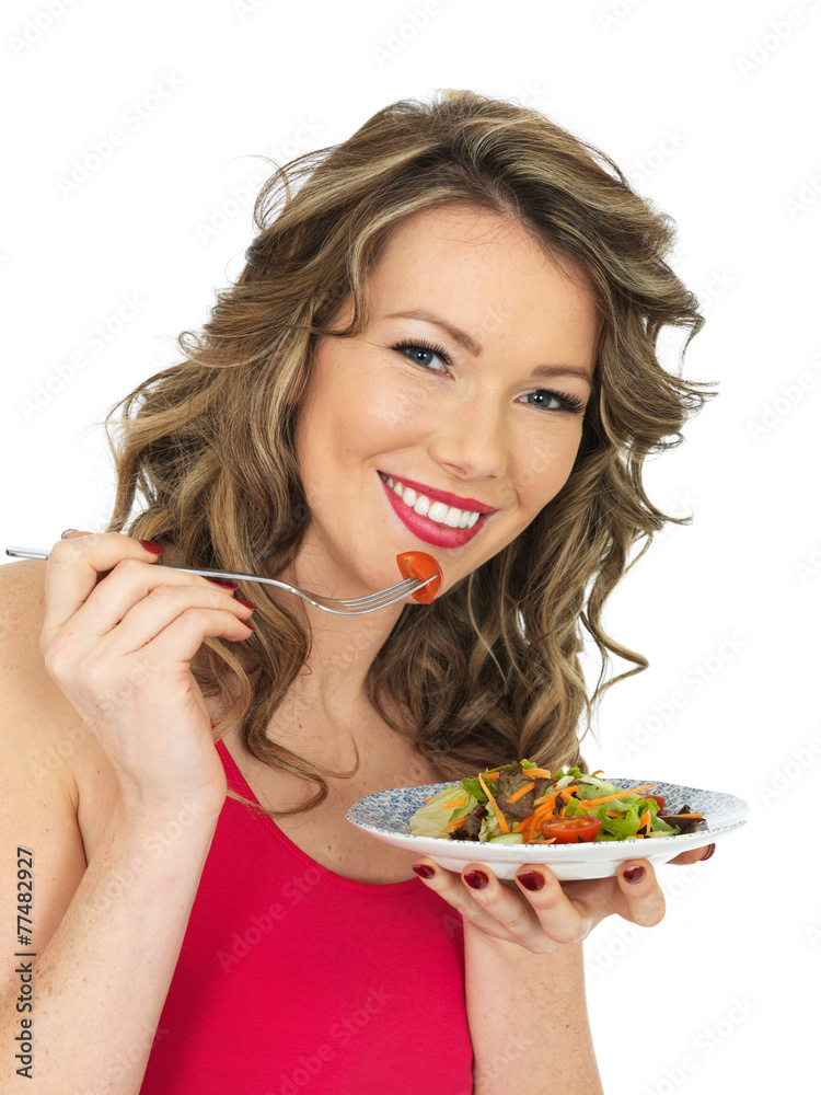 Young Woman Eating a Fresh Crispy Garden Salad Young Woman Eating a Fresh Crispy Garden Salad