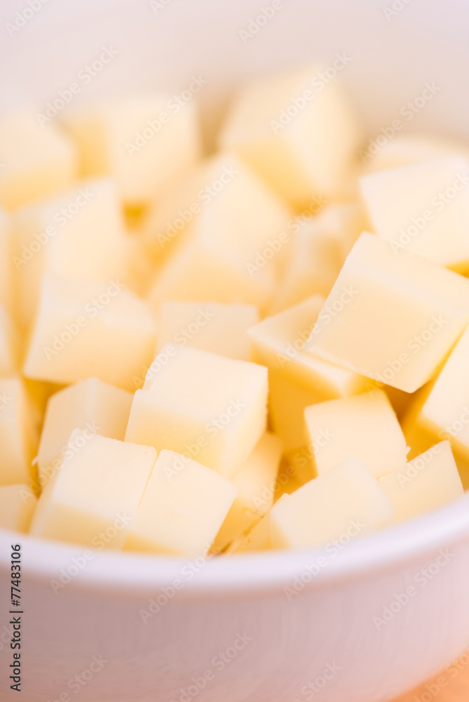 cheese cubes close up on wooden background - selective focus cheese cubes close up on wooden background - selective focus