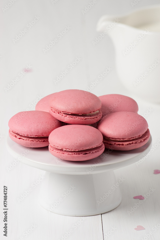 Obraz premium Macaroons Biscuits On White Stand. Paper Hearts