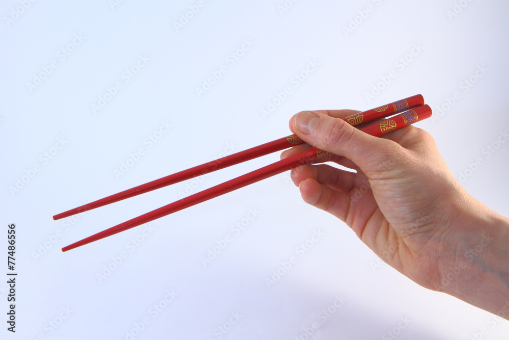 Baguettes chinoises rouges tenues - Red chopsticks Photos