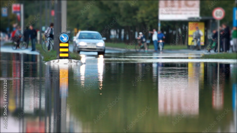 View of the main street under the water and the car passing View of the main street under the water and the car passing